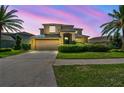 Gorgeous home showcasing lush landscaping and a vibrant twilight sky backdrop at 1314 Oak Pond St, Ruskin, FL 33570