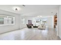 Bright living area with wood floors, modern furniture, light fixtures, and large windows that give ample natural light at 14424 59Th E Cir, Bradenton, FL 34211