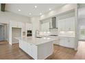 Bright kitchen featuring an island, white cabinets, stainless steel appliances and modern finishes at 14531 Swiss Bridge Dr, Lithia, FL 33547