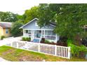 Charming home with a well-kept lawn and a classic white picket fence at 1510 Mobile Ave, Tampa, FL 33610