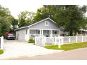 Beautifully renovated home with a paved driveway and a charming picket fence at 1510 Mobile Ave, Tampa, FL 33610