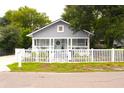 Inviting single story home with a well-manicured lawn and a white picket fence at 1510 Mobile Ave, Tampa, FL 33610