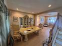 Ornate dining room featuring classic details, decorative moldings, and elegant furniture with a large dining table at 16027 Vine Cliff Ave, Hudson, FL 34667