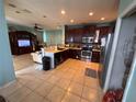 Spacious kitchen boasts stainless appliances, dark cabinets, and seamless flow into living area at 16027 Vine Cliff Ave, Hudson, FL 34667