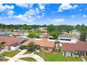 Spacious property in a quiet neighborhood showcasing mature trees and well-maintained landscaping at 2119 Sugarbush Dr, Holiday, FL 34690