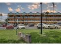 Exterior shot of the Ottoman condo buildings with parking and landscaping on a partially cloudy day at 2466 Ecuadorian Way # 32, Clearwater, FL 33763