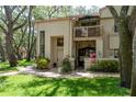 Charming townhouse featuring a private balcony, manicured lawn and brick-paved walkway to the front door at 247 Los Prados Dr # 1123, Safety Harbor, FL 34695