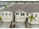 This is a slightly elevated view of the exterior of these townhomes and attached garages at 26082 Woven Wicker Bnd, Lutz, FL 33559