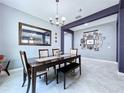 Inviting dining room featuring modern chandelier, large mirror, and decorative wall art, perfect for Gathering gatherings at 2798 Hilliard Dr, Wesley Chapel, FL 33543