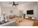 Bright living room featuring modern furniture, a ceiling fan, and hardwood floors at 310 Arbor E Dr, Palm Harbor, FL 34683