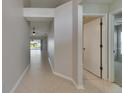 Hallway with tile flooring provides view of backyard and access to adjacent rooms at 318 Lookout Dr, Apollo Beach, FL 33572