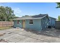 Rear exterior view of a renovated home showing a door and fenced yard at 3201 36Th N Ave, St Petersburg, FL 33713