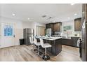 Modern kitchen with stainless steel appliances, kitchen island, and bar stool seating at 3201 36Th N Ave, St Petersburg, FL 33713
