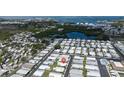 Aerial view of a 55+ community by the water with manufactured homes and lots of green spaces at 3301 Alt 19 # 317, Palm Harbor, FL 34683