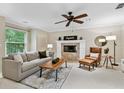 Cozy living room featuring a fireplace, comfortable seating, and stylish decor at 344 Cascade Ln, Palm Harbor, FL 34684