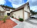 Beige two-story townhome with two car garage and shuttered windows at 4006 Huxford Ct, Tampa, FL 33624