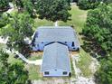 Aerial view of a home with a gray roof, showcasing the spacious lot and lush greenery at 5007 Booth Rd, Plant City, FL 33565