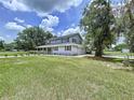 Beautiful two story home with large manicured front lawn and inviting front porch at 5007 Booth Rd, Plant City, FL 33565