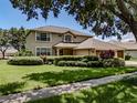 Beautiful two-story home showcasing mature trees, a well-maintained lawn, and inviting curb appeal at 5315 Cedarshake Ln, Valrico, FL 33596