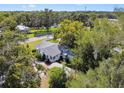 An aerial view of a cozy home nestled among lush trees at 5906 12Th St, Zephyrhills, FL 33542