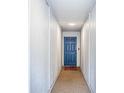 Bright hallway featuring neutral walls, a blue front door, and unique flooring at 6206 92Nd N Pl # 3605, Pinellas Park, FL 33782