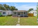 Charming single-story home featuring a well-manicured lawn and inviting front porch with decorative stepping stones at 744 53Rd N Ter, St Petersburg, FL 33703