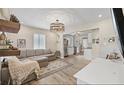 Open-concept living area featuring hardwood floors, a comfortable sofa, and plenty of natural light at 744 53Rd N Ter, St Petersburg, FL 33703