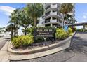 Prelude 80 building entrance sign, featuring visitor parking directions and nicely maintained landscaping at 80 Rogers St # 2D, Clearwater, FL 33756