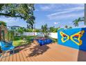 Enjoy outdoor living on this back yard deck with blue and yellow painted accent wall and a hot tub at 8074 37Th N Ave, St Petersburg, FL 33710