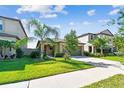 Charming single-story home boasts lush landscaping and a well-maintained lawn at 9437 Lemon Drop Loop, Sun City Center, FL 33573