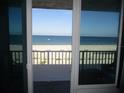 Beachfront view from the balcony, overlooking the sand and ocean at 9980 Gulf Blvd # 408, Treasure Island, FL 33706