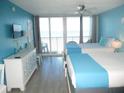 Inviting bedroom with two beds and balcony access, providing serene views and ample natural light at 9980 Gulf Blvd # 408, Treasure Island, FL 33706