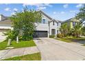 Charming two-story home featuring a well-manicured lawn and a two-car garage at 11541 Tangle Branch Ln, Gibsonton, FL 33534