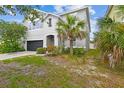 View of a two-story home featuring a well-manicured lawn at 11541 Tangle Branch Ln, Gibsonton, FL 33534