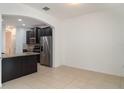 Well-lit kitchen with stainless steel appliances, dark cabinetry, and granite countertops at 11918 Winterset Cove Dr, Riverview, FL 33579