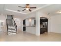 Open-concept living area with staircase, granite countertops, and stainless steel appliances at 11918 Winterset Cove Dr, Riverview, FL 33579