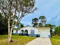 Charming home featuring clean lines, landscaped front yard, and inviting entryway at 13186 Thrush St, Spring Hill, FL 34609