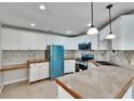 Bright kitchen with white cabinets, modern appliances, and wood-trimmed countertops at 1331 Coolmont Dr, Brandon, FL 33511