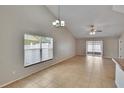 Spacious living room with tile floors, vaulted ceilings, and sliding door access to the outdoors at 1331 Coolmont Dr, Brandon, FL 33511