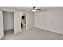 Cozy main bedroom with carpeted floors, ceiling fan, and en-suite bathroom at 1331 Coolmont Dr, Brandon, FL 33511