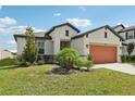 Beautiful single-story home boasts a well-maintained lawn and an attached two-car garage at 13515 Palmera Vista Dr, Riverview, FL 33579
