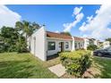 A single-story home with beautiful lawn, mature trees, and a well-maintained exterior at 13710 Mission Oaks Blvd # 2A, Seminole, FL 33776