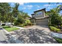 Beautiful home with landscaped front yard, brick driveway, and well-maintained lawn at 1391 Marinella Dr, Palm Harbor, FL 34683