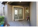 Charming front porch with double doors and decorative welcome mat at 1391 Marinella Dr, Palm Harbor, FL 34683