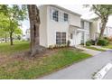 Charming townhome featuring large windows and a well-maintained lawn, offering a cozy and inviting curb appeal at 16175 Rambling Vine E Dr, Tampa, FL 33624