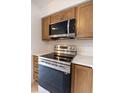 Close up of the stainless steel oven, microwave, and quartz countertop at 16175 Rambling Vine E Dr, Tampa, FL 33624