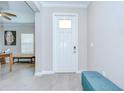 Bright foyer with wood-look tile flooring and neutral paint, creating a welcoming entrance at 17140 Holly Well Ave, Wimauma, FL 33598
