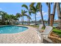 Relaxing backyard pool area with comfortable lounge seating, and a waterfront view at 202 Howard Dr, Belleair Beach, FL 33786