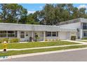 Lovely single story home featuring green grass, a private garage and a sidewalk at 204 Mindy Dr, Largo, FL 33771