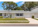 Inviting single story home with a well-manicured lawn, a private garage, and pleasant landscaping at 204 Mindy Dr, Largo, FL 33771